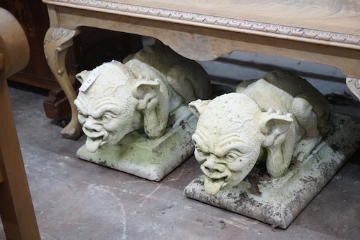 A pair of stone gargoyle garden ornaments, length 60cm, depth 30cm, height 32cm